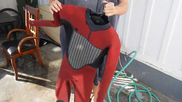 Extend hanger shoulders once inside wetsuit